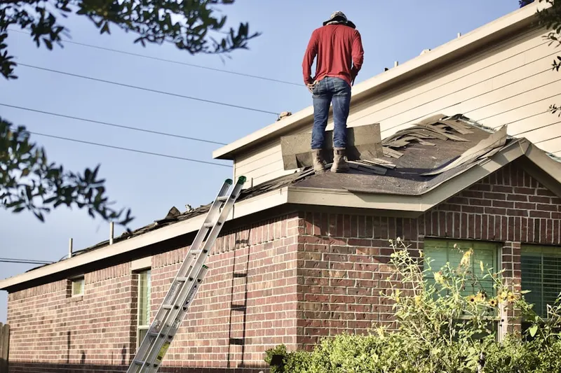Professional roofer working on a residential roof in Lake Thomas